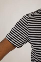 Upper black white striped shirt brown jeans of Arturo